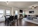Comfortable living room with stone fireplace, ceiling fan, and access to dining area at 675 Mallard Cv, Loganville, GA 30052