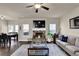 Cozy living room with stone fireplace, neutral color palette, and ample seating at 675 Mallard Cv, Loganville, GA 30052
