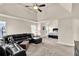 Spacious living room featuring a ceiling fan, and a comfortable, oversized black leather sofa at 675 Mallard Cv, Loganville, GA 30052