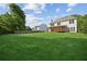 Expansive backyard with lush green grass and mature trees, providing privacy and space at 7025 Coffield Ct, Cumming, GA 30041