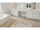 A bright main bathroom features a soaking tub, dual sinks, and abundant countertop space at 7025 Coffield Ct, Cumming, GA 30041