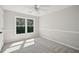 Neutral bedroom with a window with plenty of light shining on the plush carpet at 7025 Coffield Ct, Cumming, GA 30041