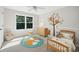 Bright bedroom featuring a woodland theme, plush carpeting, and a large window at 7025 Coffield Ct, Cumming, GA 30041