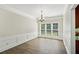 Dining room with hardwood floors, paneled walls, and large windows with blinds at 7025 Coffield Ct, Cumming, GA 30041