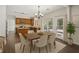 Dining room view showcases the kitchen, deck access, and modern decor at 7025 Coffield Ct, Cumming, GA 30041