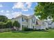 Two-story home with manicured lawn, black shutters, and picket fence at 7025 Coffield Ct, Cumming, GA 30041