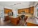 The modern kitchen offers stainless steel appliances, a center island, and gorgeous granite counters at 7025 Coffield Ct, Cumming, GA 30041