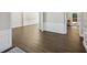 Open-concept living space with wood floors, white trim, and lots of natural light at 7025 Coffield Ct, Cumming, GA 30041