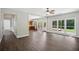 Open floor plan showcasing living room with hardwood floors and view to the kitchen and outdoor deck at 7025 Coffield Ct, Cumming, GA 30041