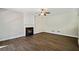 Spacious living room with a decorative fireplace and hardwood floors at 7025 Coffield Ct, Cumming, GA 30041