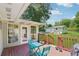 View from the outdoor deck showcasing the manicured lawn, outdoor shed, and natural surrounding landscape at 905 Scott Sw Ln, Marietta, GA 30008