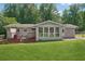 Expansive backyard with a deck, shed, and well-maintained lawn with mature trees, offering ample outdoor space at 905 Scott Sw Ln, Marietta, GA 30008