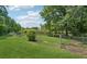 Expansive backyard with full fencing, trees, and a lush lawn provides privacy at 905 Scott Sw Ln, Marietta, GA 30008