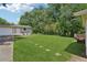Spacious backyard with large grassy lawn and bordered by mature trees and fencing at 905 Scott Sw Ln, Marietta, GA 30008