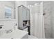 This bathroom offers a shower with white tile, a vanity cabinet and great lighting at 905 Scott Sw Ln, Marietta, GA 30008