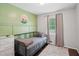 Charming bedroom with a cozy single bed, soothing wall color, and a window at 905 Scott Sw Ln, Marietta, GA 30008