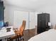 Well-lit bedroom featuring hardwood floors, spacious closet, and modern desk area at 905 Scott Sw Ln, Marietta, GA 30008
