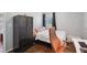 Cozy bedroom featuring hardwood floors, a large wardrobe, and a well-lit workspace at 905 Scott Sw Ln, Marietta, GA 30008