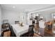 Bright dining room with a modern table setting, hardwood floors, and open access to the kitchen at 905 Scott Sw Ln, Marietta, GA 30008