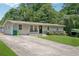 A well kept home with a large driveway and a beautifully landscaped front yard at 905 Scott Sw Ln, Marietta, GA 30008