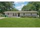 Attractive single-story home featuring a lush lawn and flowerbeds enhancing curb appeal at 905 Scott Sw Ln, Marietta, GA 30008