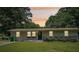 Charming single-story home with a well-manicured lawn, garden, and welcoming front entrance at 905 Scott Sw Ln, Marietta, GA 30008