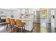 Bright kitchen with stainless appliances, white cabinets, breakfast bar, and view to dining area and sunroom at 905 Scott Sw Ln, Marietta, GA 30008