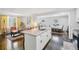 Open floor plan showcasing the kitchen island, stainless sink, and hardwood floors flowing into the living space at 905 Scott Sw Ln, Marietta, GA 30008