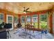 This sunroom features wood walls, lots of natural light, and room for a desk and chair at 905 Scott Sw Ln, Marietta, GA 30008