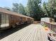 Large back deck with wooden railings, room for outdoor furniture and wooded area at 224 Potts Se Rd, Conyers, GA 30094