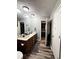 Bathroom featuring double sinks, wood flooring and a neutral wall color at 224 Potts Se Rd, Conyers, GA 30094
