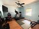 Bedroom features wood flooring, ceiling fan, TV and fitness equipment at 224 Potts Se Rd, Conyers, GA 30094
