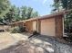 Ranch home with attached garage, wooden exterior and front yard landscaping at 224 Potts Se Rd, Conyers, GA 30094