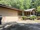 View of the home's attached two car garage and covered porch with white railing and siding at 224 Potts Se Rd, Conyers, GA 30094