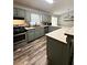 Kitchen features stainless steel appliances, sage cabinets and wood flooring at 224 Potts Se Rd, Conyers, GA 30094