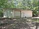 Shed with roll up door for extra storage on a beautiful lot at 224 Potts Se Rd, Conyers, GA 30094