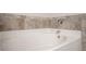 Bathroom showcasing the bathtub with a tiled backsplash and chrome faucet at 2544 Castellan Dr, Atlanta, GA 30316