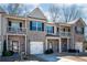 Attractive townhouse exterior with stone accents, small porch, and a one-car garage at 2544 Castellan Dr, Atlanta, GA 30316