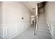 Hallway with carpet, white trim, staircase, and view into an open kitchen area at 2544 Castellan Dr, Atlanta, GA 30316