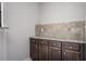 Kitchen cabinetry with stone countertops and tiled backsplash in a modern home at 2544 Castellan Dr, Atlanta, GA 30316