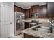 Kitchen with stainless steel appliances, granite countertops, and dark wood cabinets at 2544 Castellan Dr, Atlanta, GA 30316
