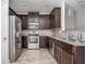 Kitchen with stainless steel appliances and dark wood cabinets at 2544 Castellan Dr, Atlanta, GA 30316