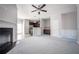 Spacious living room with neutral paint, plush carpeting, fireplace, and kitchen with stainless steel appliances at 2544 Castellan Dr, Atlanta, GA 30316