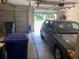 View of a garage interior with car, storage shelves and trash receptacles offering convenience and space at 318 Summit View Dr, Mcdonough, GA 30253