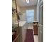 Bright laundry room features washer, dryer, storage shelves, and natural light from the window at 318 Summit View Dr, Mcdonough, GA 30253