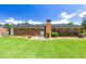 Brick home with patio, black roof, and expansive grassy backyard at 4172 N Martin Way, Lithia Springs, GA 30122