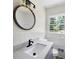 Bathroom featuring updated vanity, modern lighting, and a large mirror at 4172 N Martin Way, Lithia Springs, GA 30122