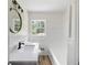 Clean bathroom with white tile, new vanity, and updated fixtures at 4172 N Martin Way, Lithia Springs, GA 30122