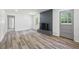 Bright living room features luxury vinyl plank flooring, brick fireplace and plenty of natural light at 4172 N Martin Way, Lithia Springs, GA 30122