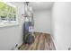Utility room with water heater and luxury vinyl plank flooring at 4172 N Martin Way, Lithia Springs, GA 30122